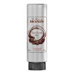 Monin dark chocolate sauce bottle for grocery use, featuring rich, smooth dark chocolate flavor in a clear plastic container.