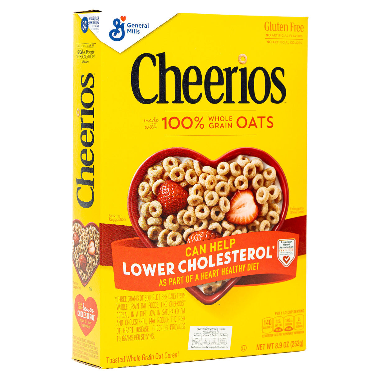 Bowl of General Mills Cheerios oat cereal in a white bowl with milk on a wooden table.