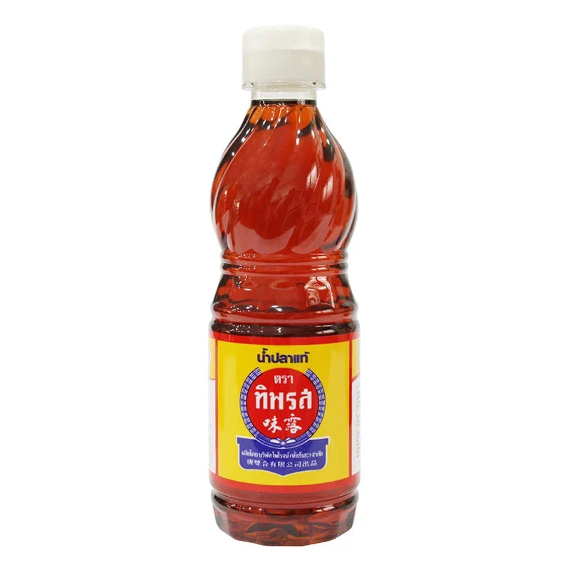 Tiparos Fish Sauce 300ml bottle with clear label, used in cooking, in a kitchen setting for dry grocery storage.