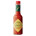 Tabasco Garlic Pepper Sauce bottle, hot sauce with garlic flavor, for adding spice to dishes in a grocery setting.