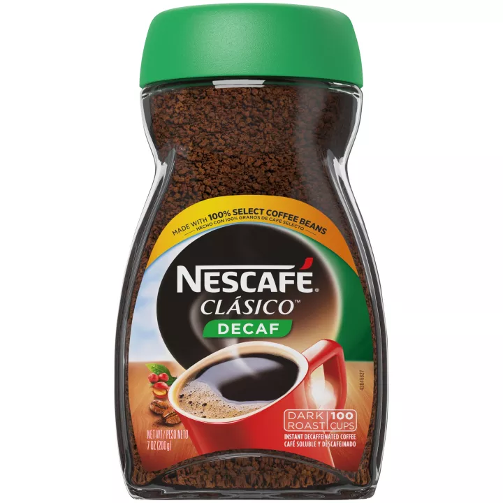Nescafe Clasico Decaf coffee powder in a jar, ready for brewing, with a label showing the Nescafe brand and decaffeinated coffee.