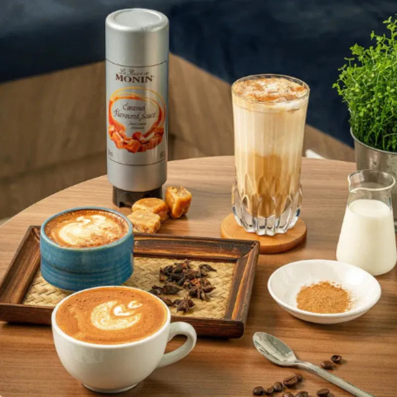 Bottle of MONIN caramel sauce, 500ml, in a clear plastic bottle with a black cap, suitable for desserts and coffee.