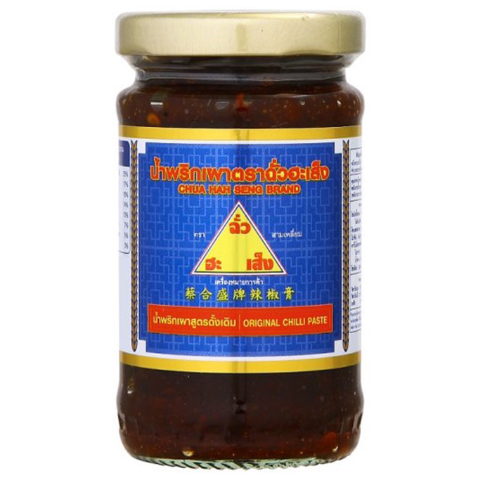 Jar of Chua Hah Seng Thai Chili Paste showing red chili ingredients and the label in a grocery setting
