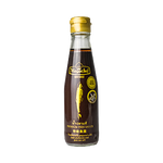 Bottle of Megachef Fish Sauce in a clear glass container with a label, used as a flavorful ingredient in cooking.