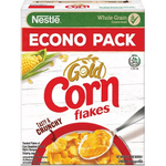 Bowl of Nestle Gold Corn Flakes cereal in a white bowl on a wooden table, with a spoon and a splash of milk.