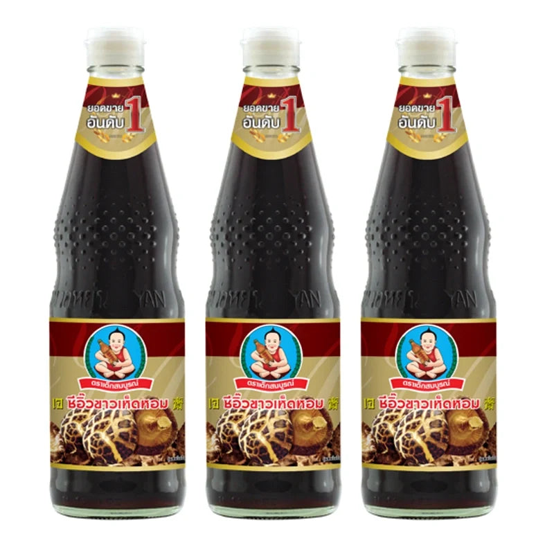 Three bottles of DEK SOM Boon Mushroom Soy Sauce, 700ml each, in clear bottles with labels, arranged on a table.