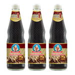 Three bottles of DEK SOM Boon Mushroom Soy Sauce, 700ml each, in clear bottles with labels, arranged on a table.