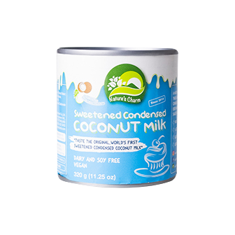 Cans of Nature's Charm sweetened condensed coconut milk, healthy coconut milk product with a creamy texture and natural ingredients.
