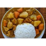 S & B Oriental Curry Powder Mix with turmeric, dry grocery spice blend in a clear container showing vibrant yellow powder.