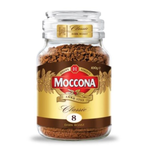 A cup of Moccona Classic Dark Roast coffee drink in a glass mug with dark coffee and frothy top, on a white surface.