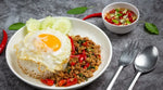 J-LEK stir-fry sauce in a 550g jar, ideal for Asian cuisine, displayed in a kitchen setting with fresh vegetables.