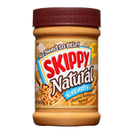 Creamy Skippy Natural Peanut Butter jar with label, smooth texture visible, in a grocery setting.