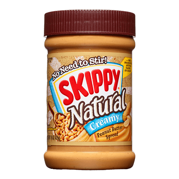 Creamy Skippy Natural Peanut Butter jar with label, smooth texture visible, in a grocery setting.