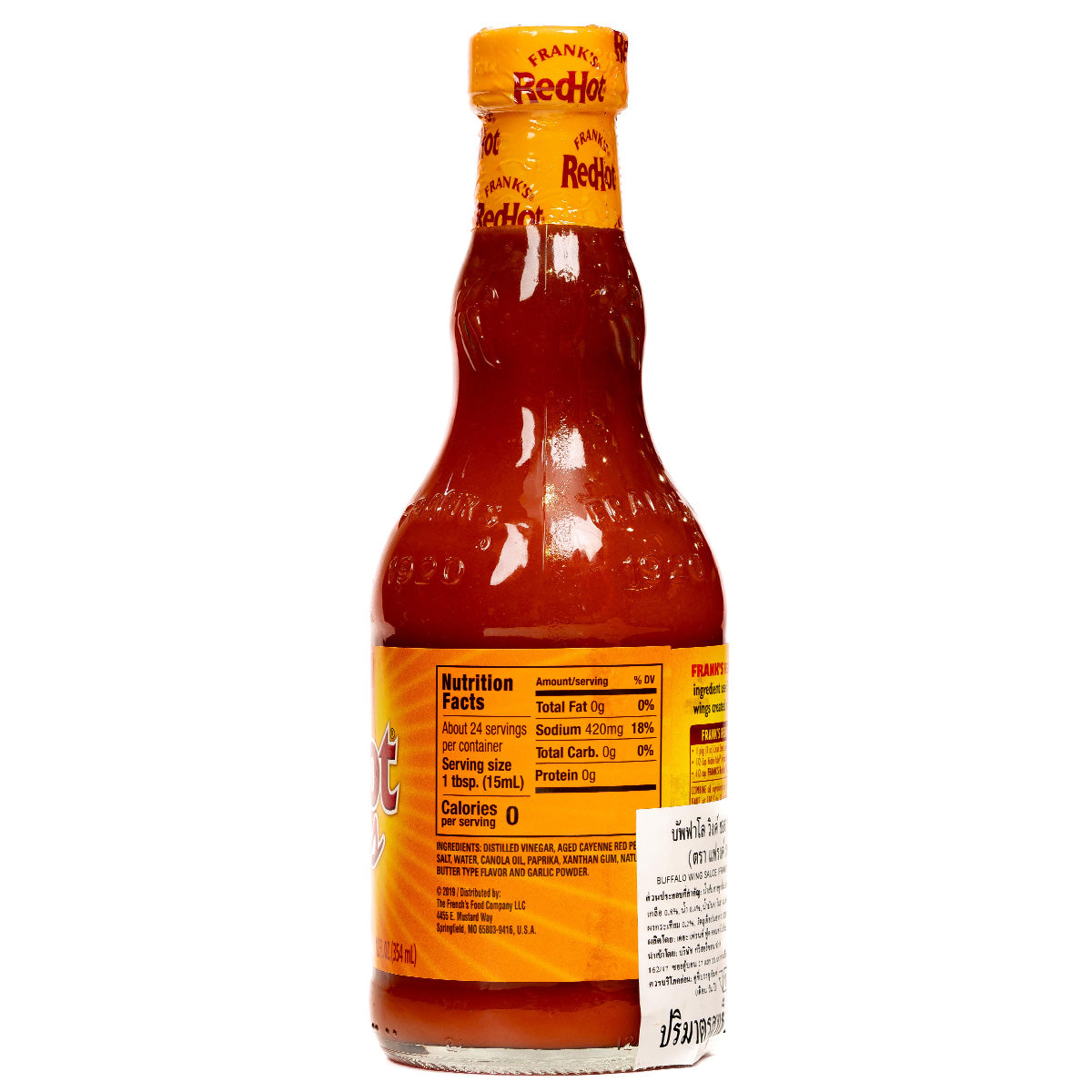 Bottle of Frank's Buffalo Wing Sauce with red label and golden cap, ready for use in spicy chicken wing recipes.