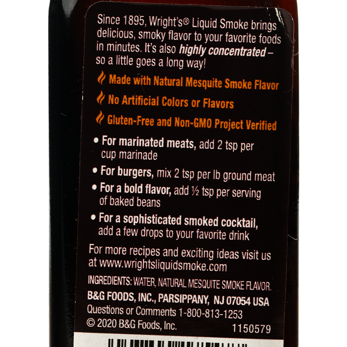 Wright Mesquite Liquid Smoke in a clear bottle, used for adding smoky flavor to grilled and smoked dishes.