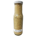 Guyvy Healthy Basil Leaf Dressing bottle for salads and dishes, featuring fresh basil ingredients in a clear glass bottle.