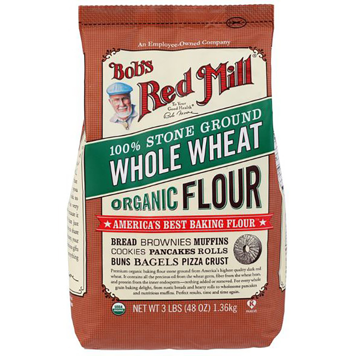 Organic whole wheat flour from Bob's Red Mill, shown in a clear bag with a scoop on a wooden surface.