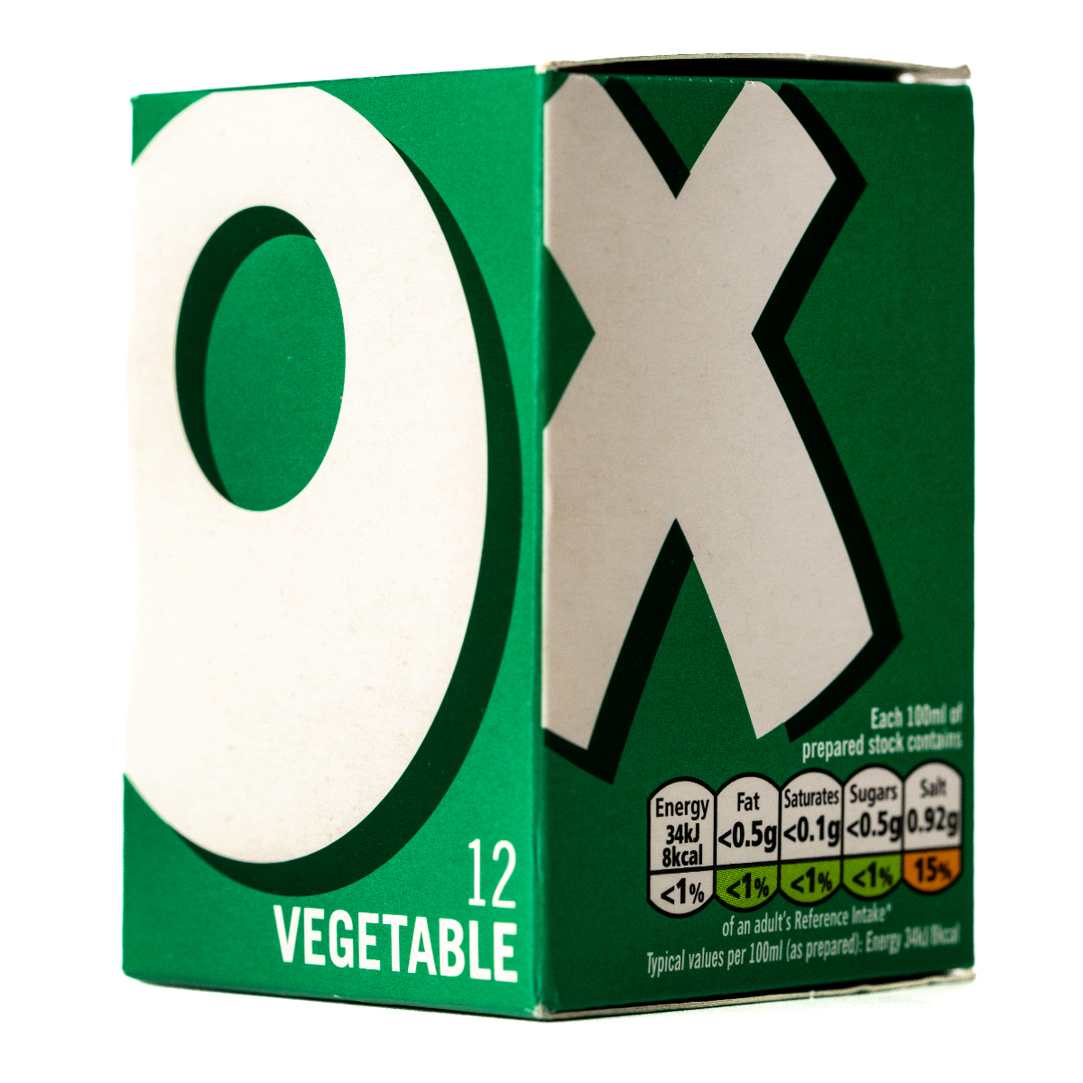 Oxo vegetable cubes in a clear container, ready for cooking, with fresh vegetables and herbs around.