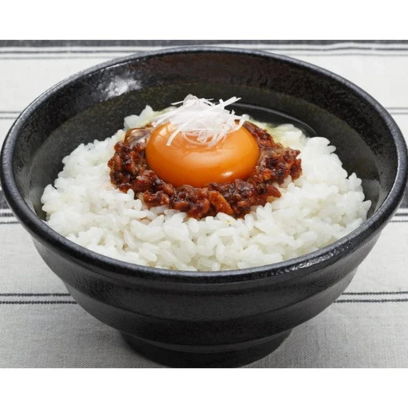 Momoya Taberu Layu Chili Oil with rapeseed and fried garlic in a jar, used for flavorful Asian cooking and dry grocery shopping.