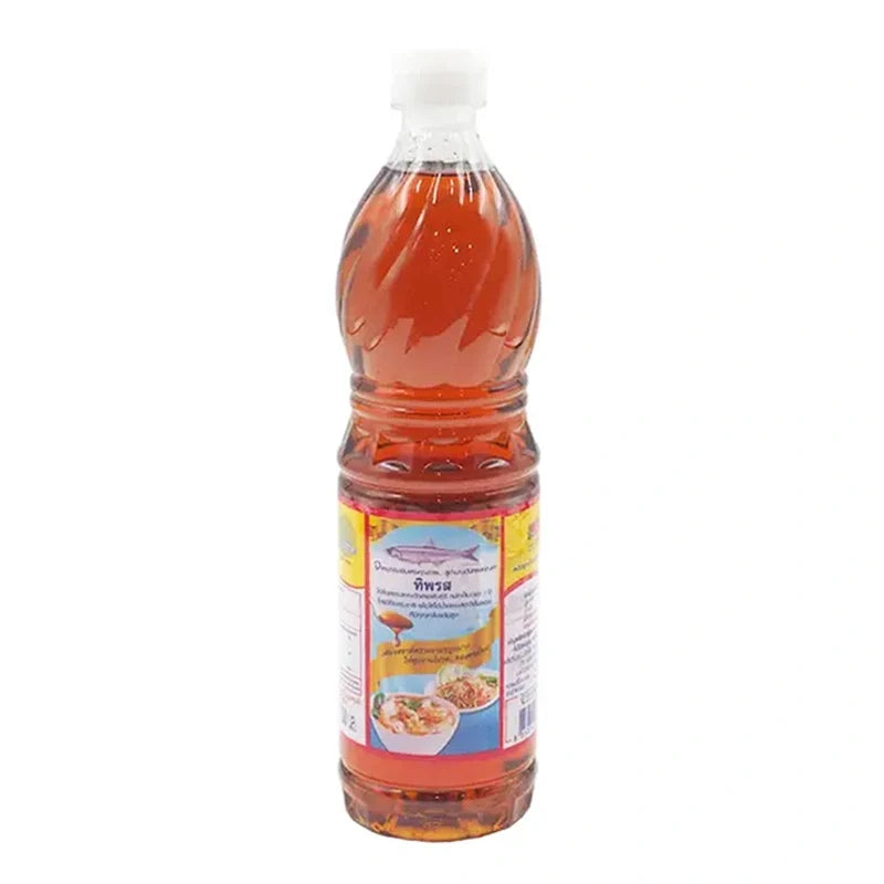 Bottle of Tiparos Fish Sauce 700ml for cooking, with clear label showing the Tiparos brand and fish sauce content in a kitchen setting.