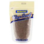 Close-up of McGarrett Flax Seed in a clear glass jar, showcasing small, golden flax seeds for healthy cooking and baking.