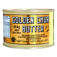 Golden Churn Pure Creamery Butter block with gold foil wrapping, showcasing its rich, creamy texture in a grocery product image.