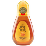 Jar of Ong Dhong Wild Flower Honey with a golden amber color, showcasing fresh honey in a clear glass container.