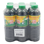 Golden Mountain Seasoning Sauce with green cap, 500ml bottle, showing the label and bottle design in a dry grocery setting.