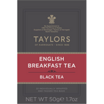 A cup of brewed Taylors English Breakfast Tea in a white mug on a wooden table, showcasing the rich amber color of the drink.