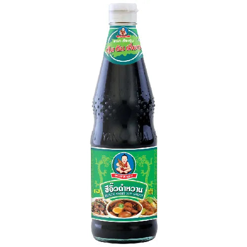 Bottle of Deksomboon Black Sweet Soy Sauce 950g, DEKSOMBOON brand, with dark soy sauce liquid visible inside the bottle.
