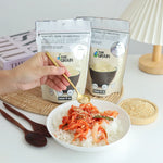 Pure Grain 100% instant roasted white sesame in 80g pack, dry grocery product with toasted sesame seeds in a clear package.