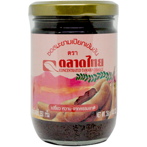 Talad Thai Tamarind Sauce bottle, a grocery product with a dark amber liquid, used for cooking and flavoring Asian dishes.