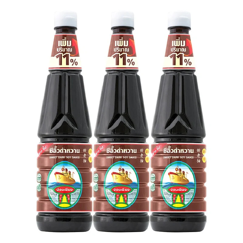 Nguan Chiang Sweet Dark Soy Sauce 950g bottle, part of a set of three, in a clear glass bottle with a dark soy liquid inside.