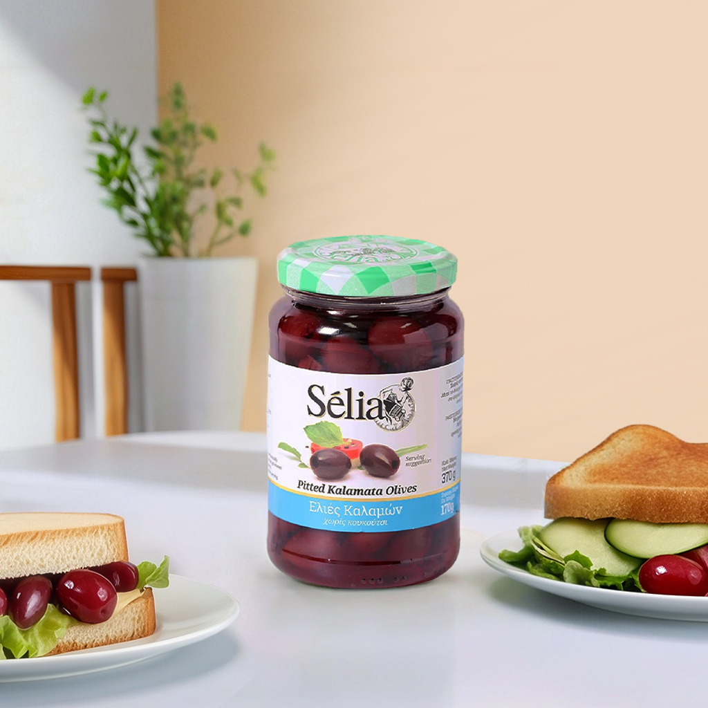 Selia pitted black Kalamata olives in a grocery jar, showing glossy, dark purple olives ready for cooking or snacking.