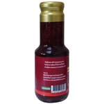 Jadjans Nam Jim Jaew, Thai-style spicy dipping sauce in a clear glass jar with red chili peppers and herbs.
