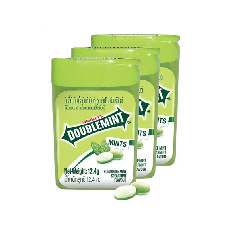 Three packs of Doublemint Spearmint Flavor Candy in 12.4g packages, featuring bright green packaging and mint candies.