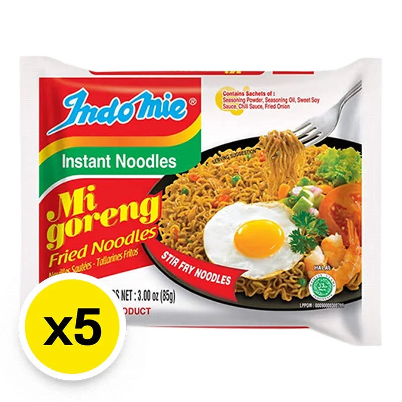 Indo Mie Mi Goreng fried noodles in 85g packs, dry grocery product, showcasing cooked noodles with seasoning and garnishes.