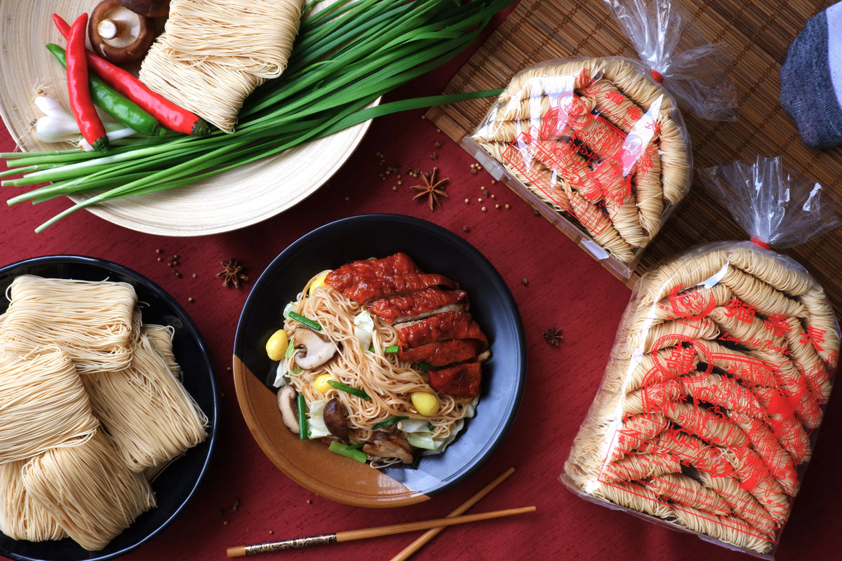 Rabbit Brand Hong Kong Style Noodles 1kg in a clear plastic bag, showing dry, uncooked noodles with a golden color.