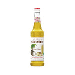 Monin Pina Colada syrup 700ml bottle for tropical cocktails, with colorful label and pouring spout, on a kitchen countertop.
