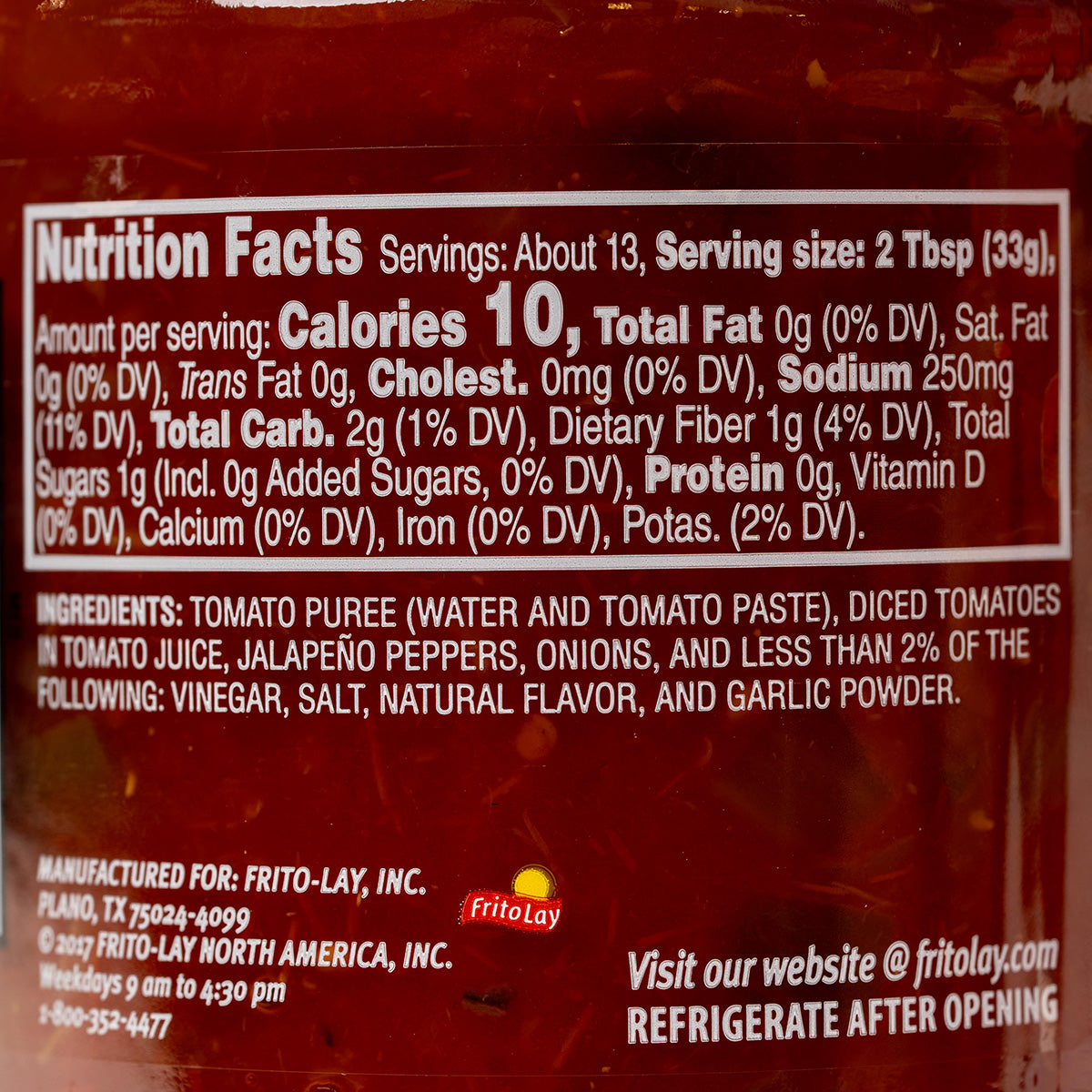 Jar of Tostitos Chunky Salsa Medium Red, a tasty grocery item with visible red salsa inside the jar.