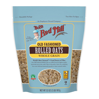 A bowl of Bob's Red Mill whole grain rolled oats, showcasing the healthy, natural oat flakes in a clear glass bowl.