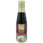 Roi Thai Tamarind Sauce bottle on a grocery shelf, showcasing the Thai-style condiment with tamarind flavor.