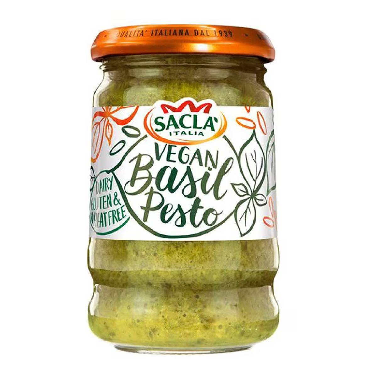 Jar of Sacla Vegan Basil Pesto with fresh basil leaves and garlic on a white background, ideal for pasta and sandwiches.