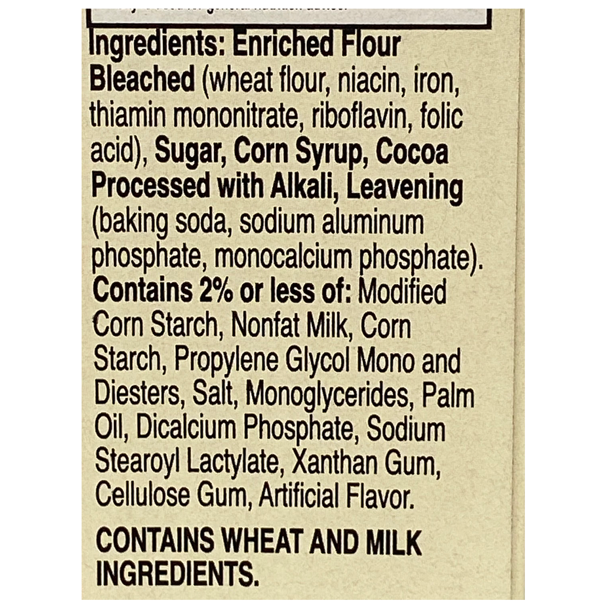 Betty Crocker Super Moist Chocolate Cake Mix box with milk, ready for baking, in a grocery setting.