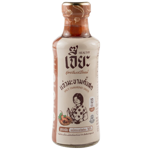 Jar of Jea Spicy Tamarind Sauce in a grocery setting, displaying the label and rich, dark sauce inside the jar.