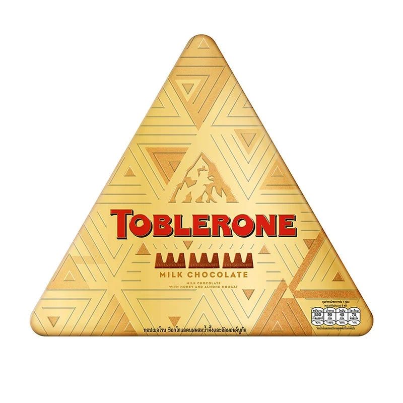 Toblerone chocolate milk festive tin containing 152g of Swiss milk chocolate triangles, designed for dry grocery shopping.