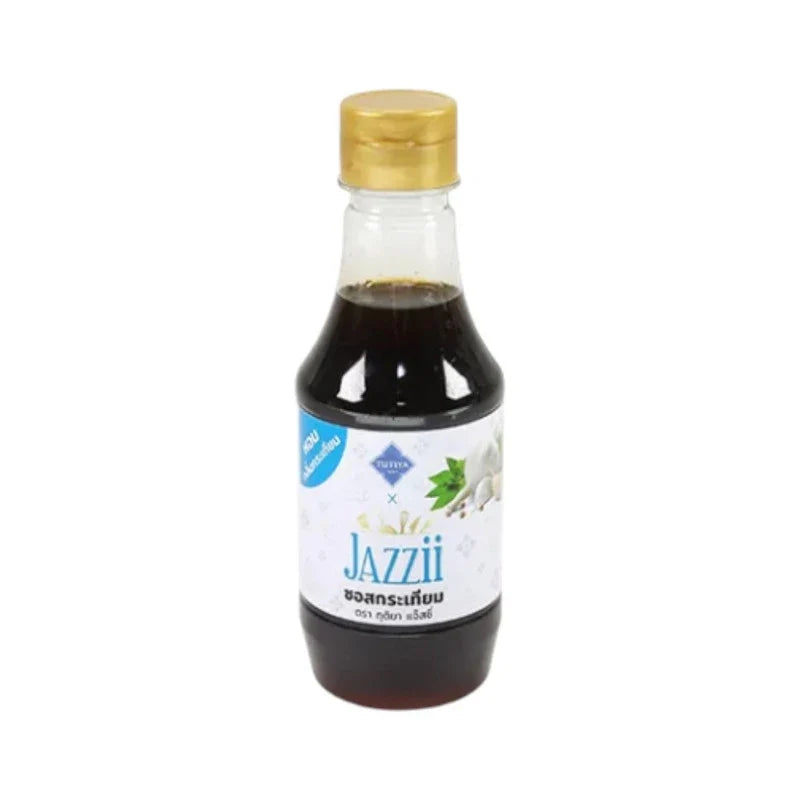 Tutiya Picante Garlic Sauce Jazzy bottle in dry grocery section, featuring vibrant label with garlic and spice illustrations.