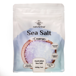 Coarse Nature First Sea Salt in a clear container, showing large salt crystals for culinary use and seasoning.