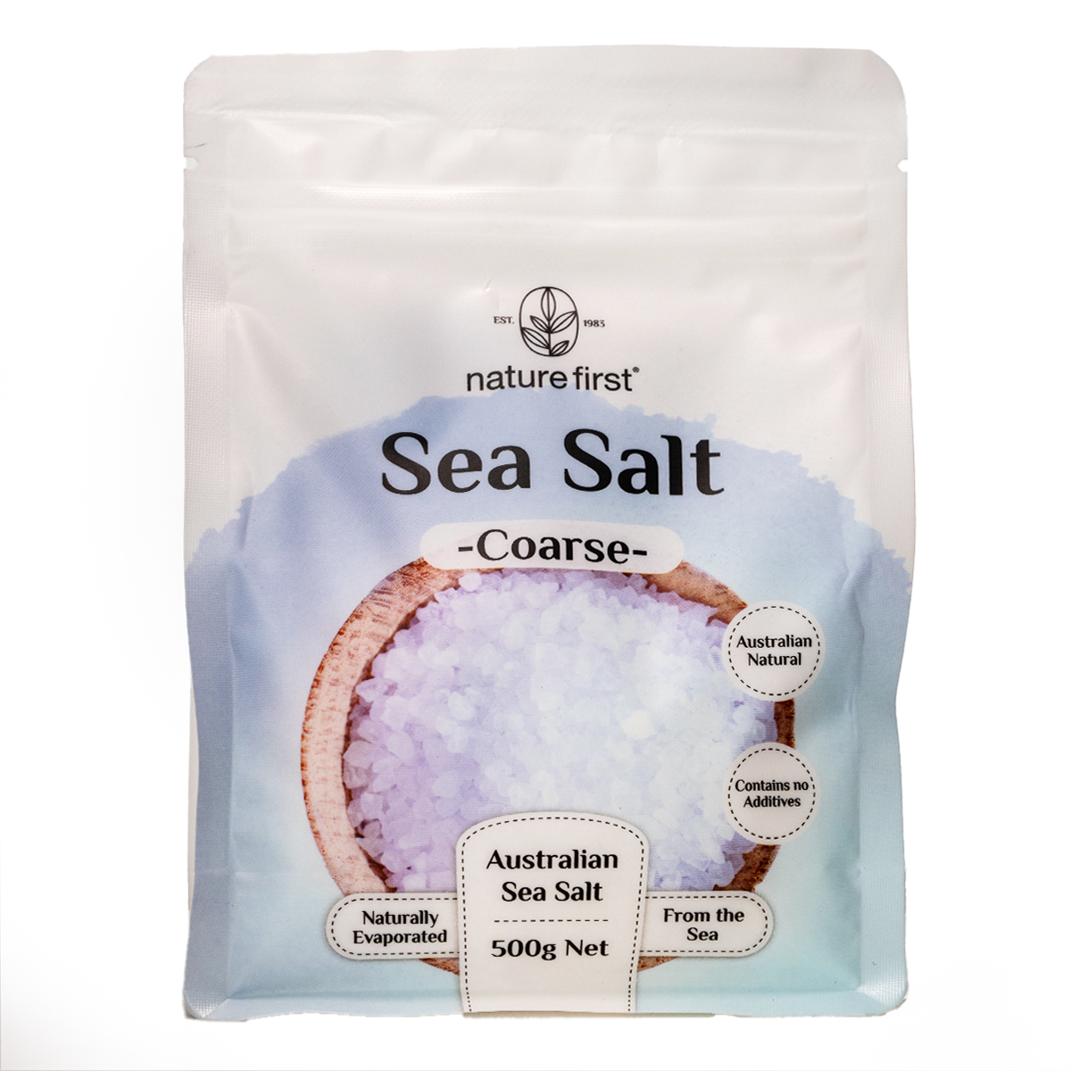 Coarse Nature First Sea Salt in a clear container, showing large salt crystals for culinary use and seasoning.