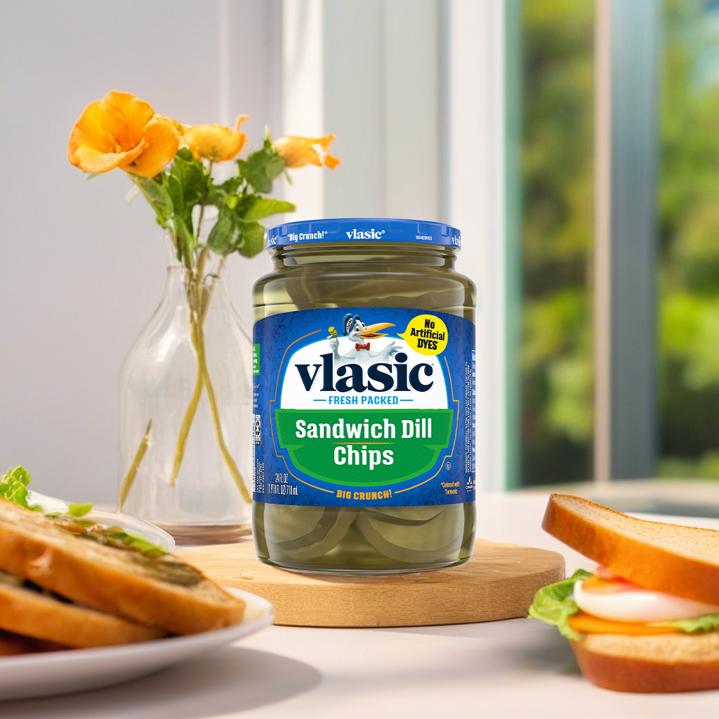 Jar of Vlasic Sandwich Dill Chips with crunchy pickles visible inside, ideal for sandwiches and snacking.
